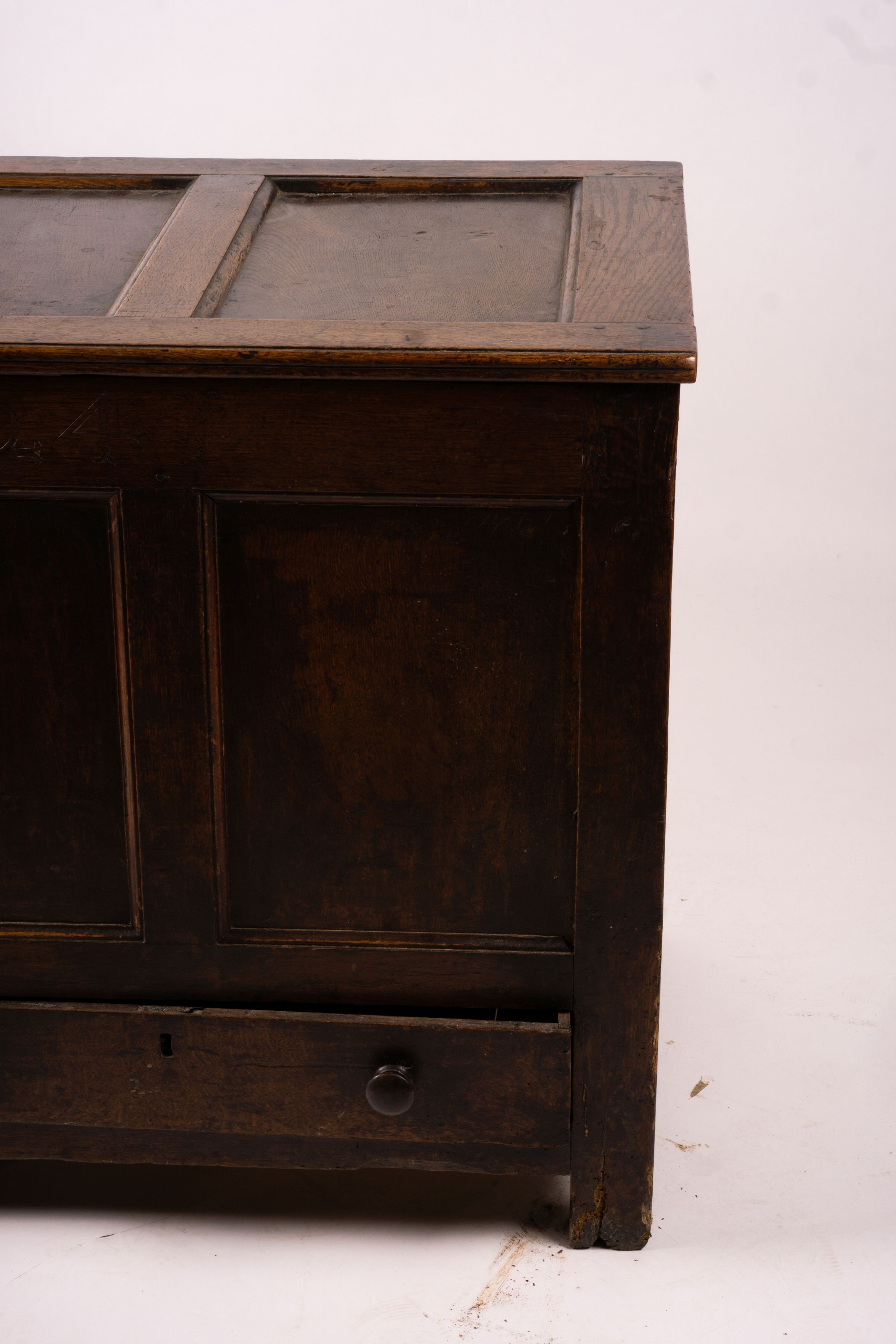 An 18th century panelled oak mule chest, length 161cm, depth 61cm, height 84cm